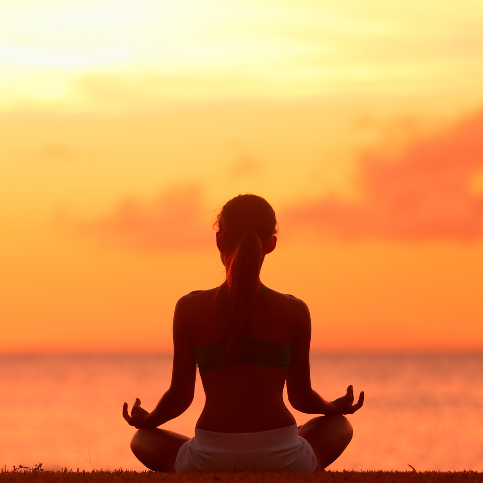 Meditating Yoga Woman at Beach Sunset